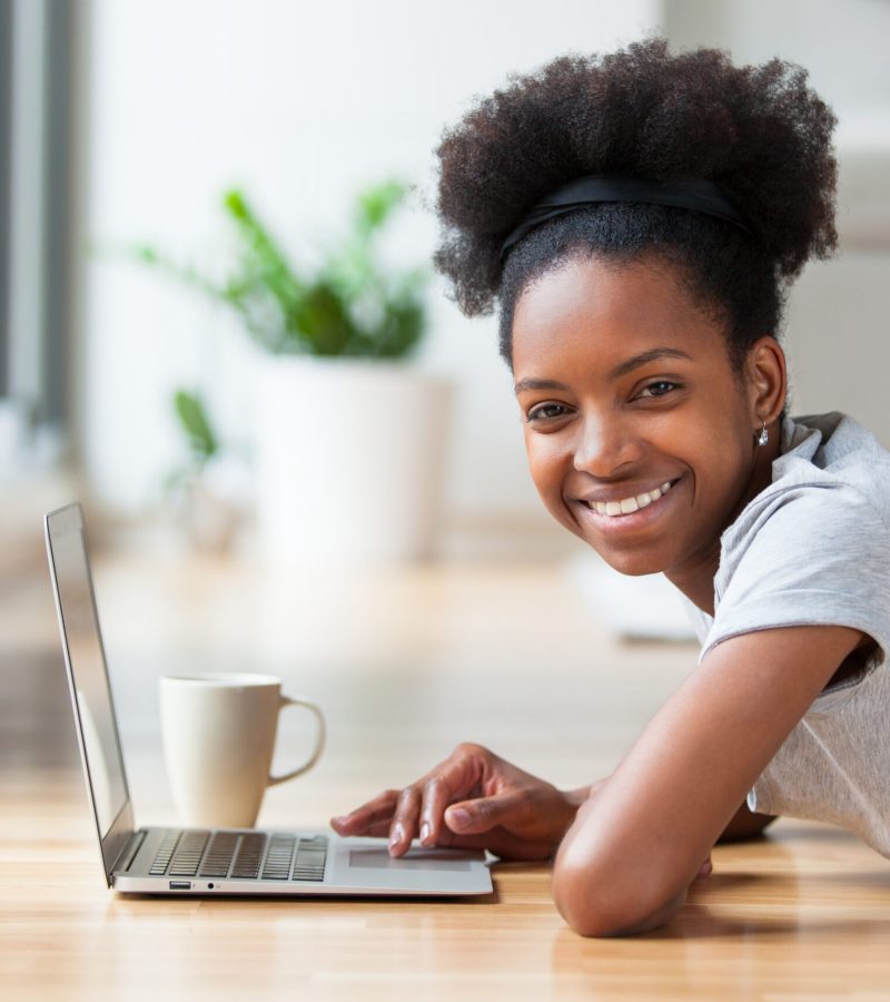 African American woman using a laptop in her living room - Black people
